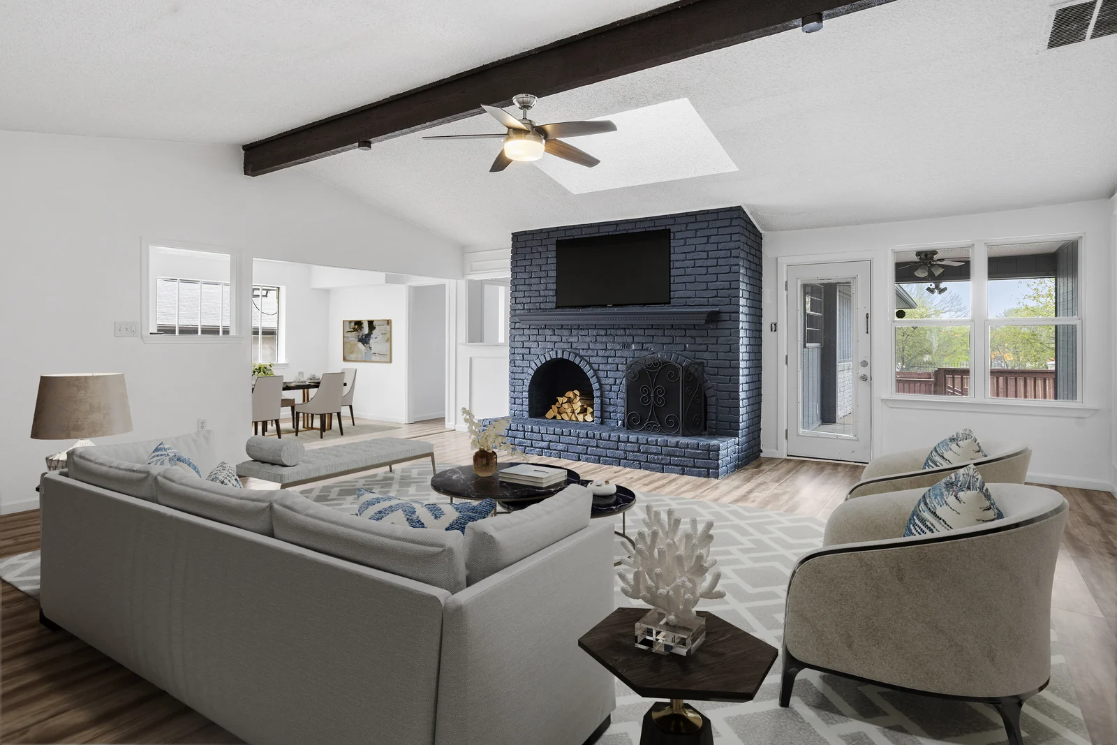 Living-room view at 1217 Pecan Valley Drive showing the fireplace, ceiling beam and skylight