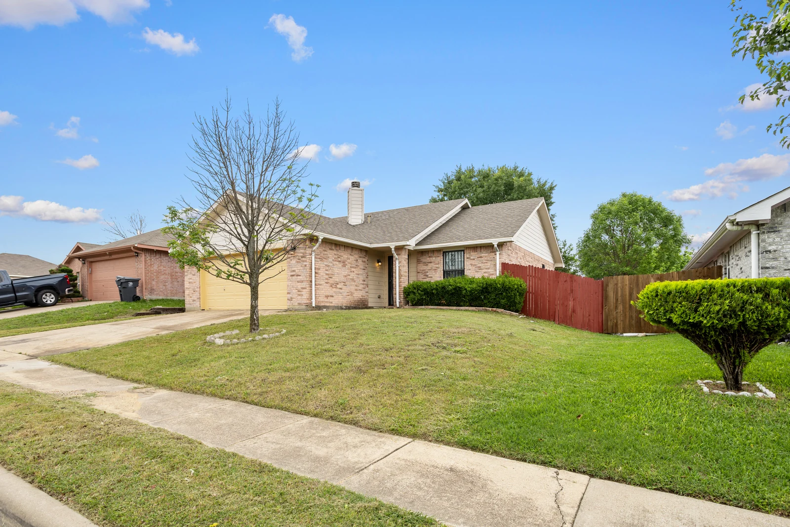 Front exterior of 1256 Cleardale Drive with the lawn, driveway and garage