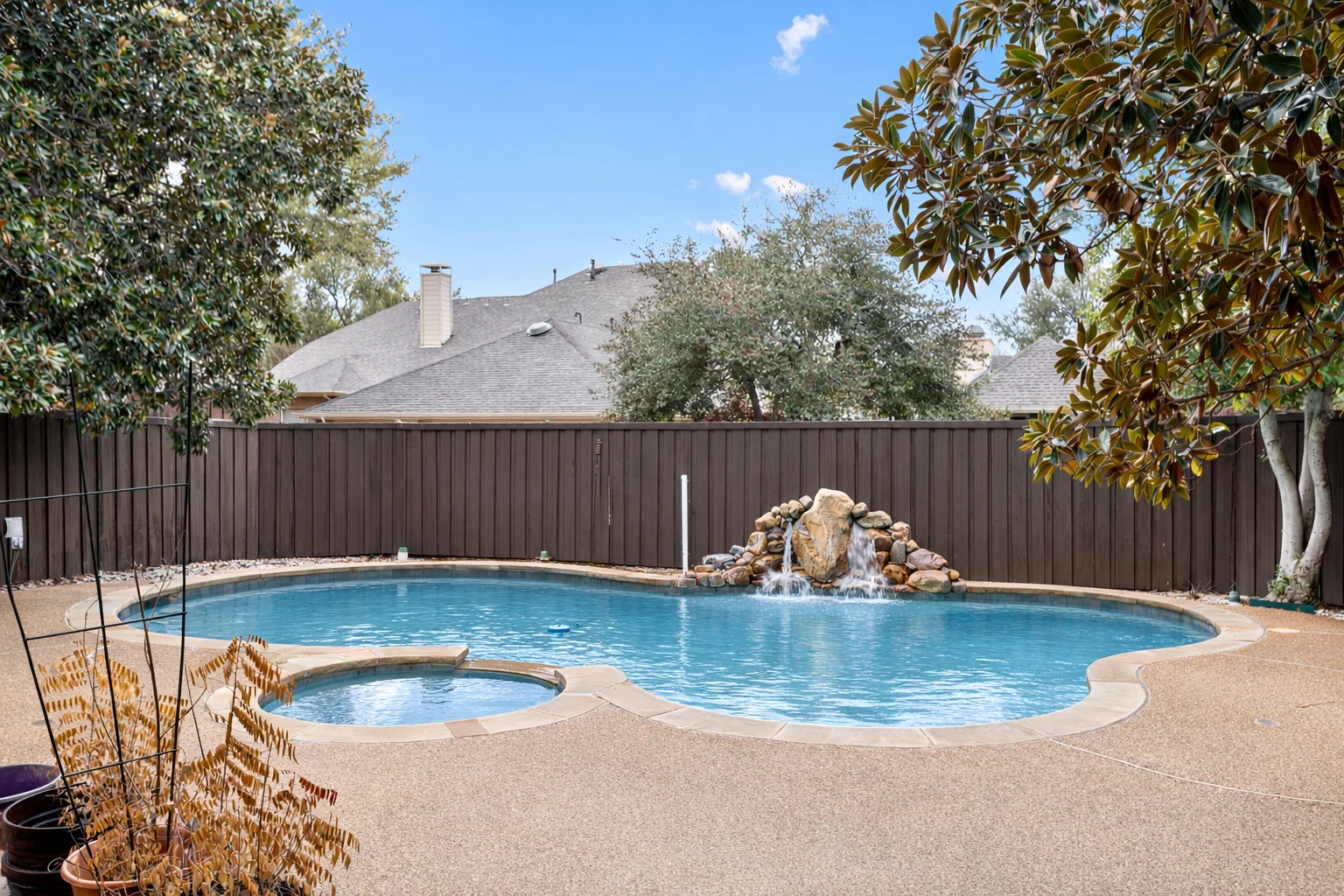 Pool view at 2312 Scenic Drive with a rock water feature and the surrounding patio