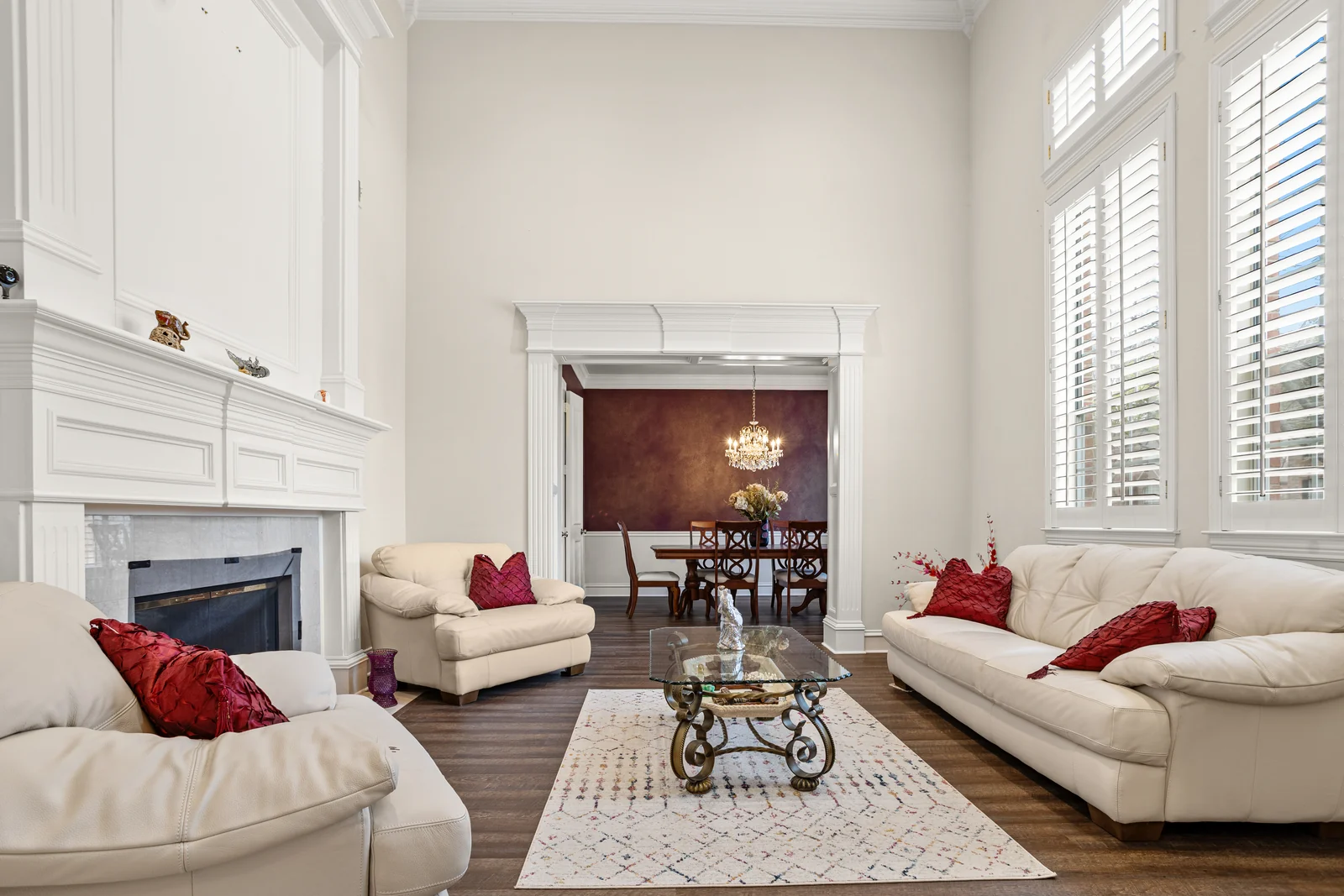 Living-room view at 2312 Scenic Drive with tall windows, a fireplace and the dining room beyond