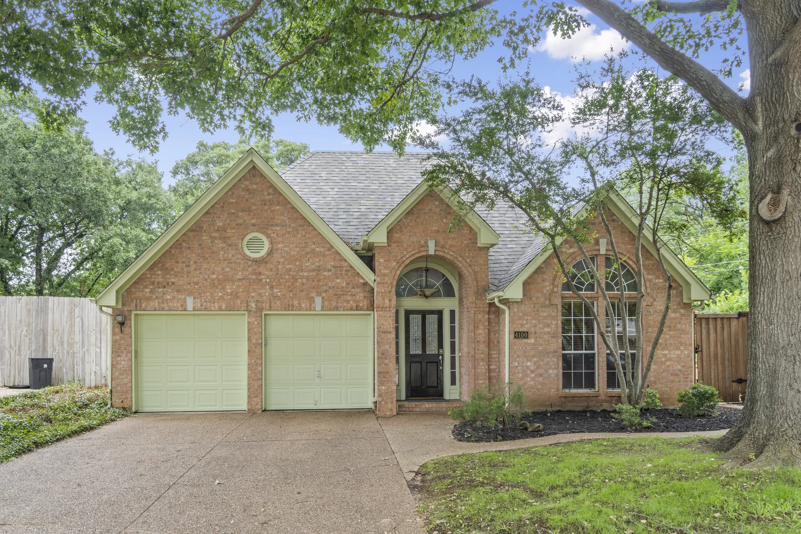 Front exterior of 4100 Crest Ridge Drive framed by trees