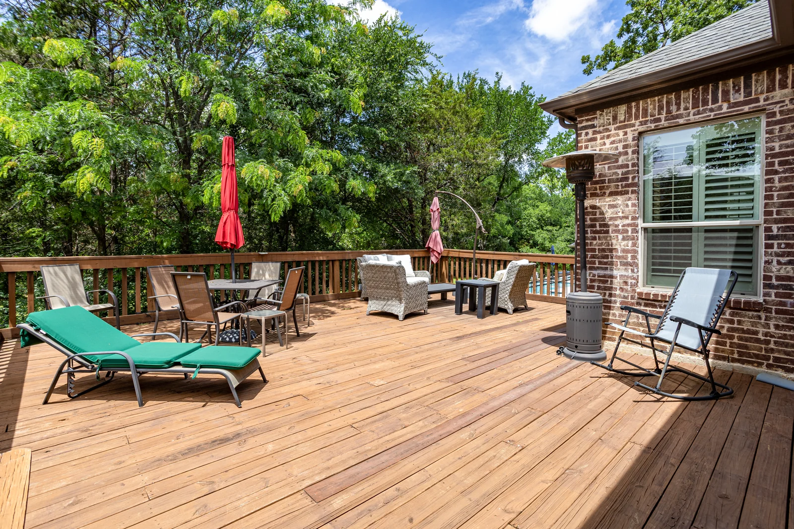 Deck at 5100 Swisher Road with outdoor seating and trees behind