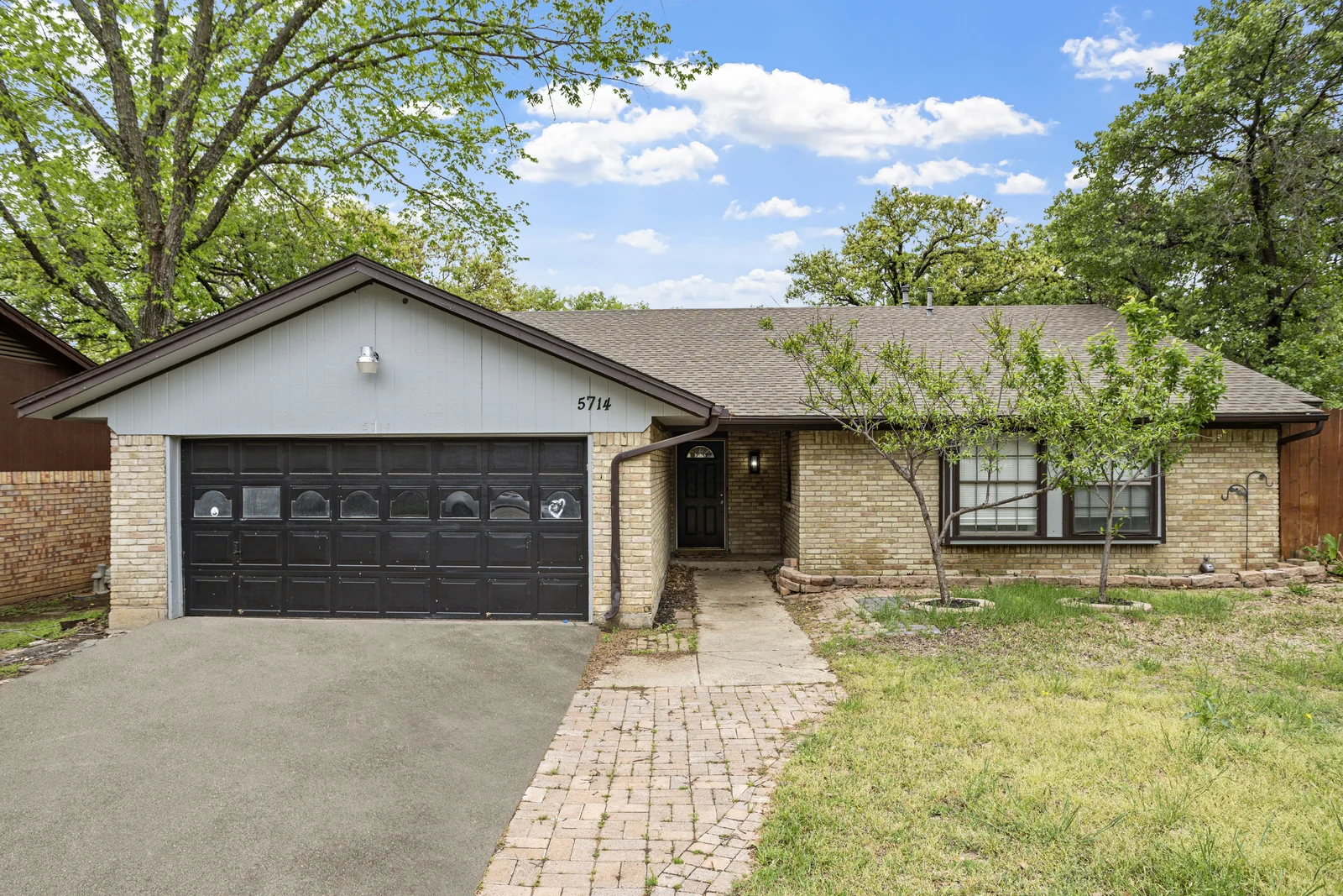 Front exterior of 5714 Tumbleweed Court with the driveway, garage and entry walkway