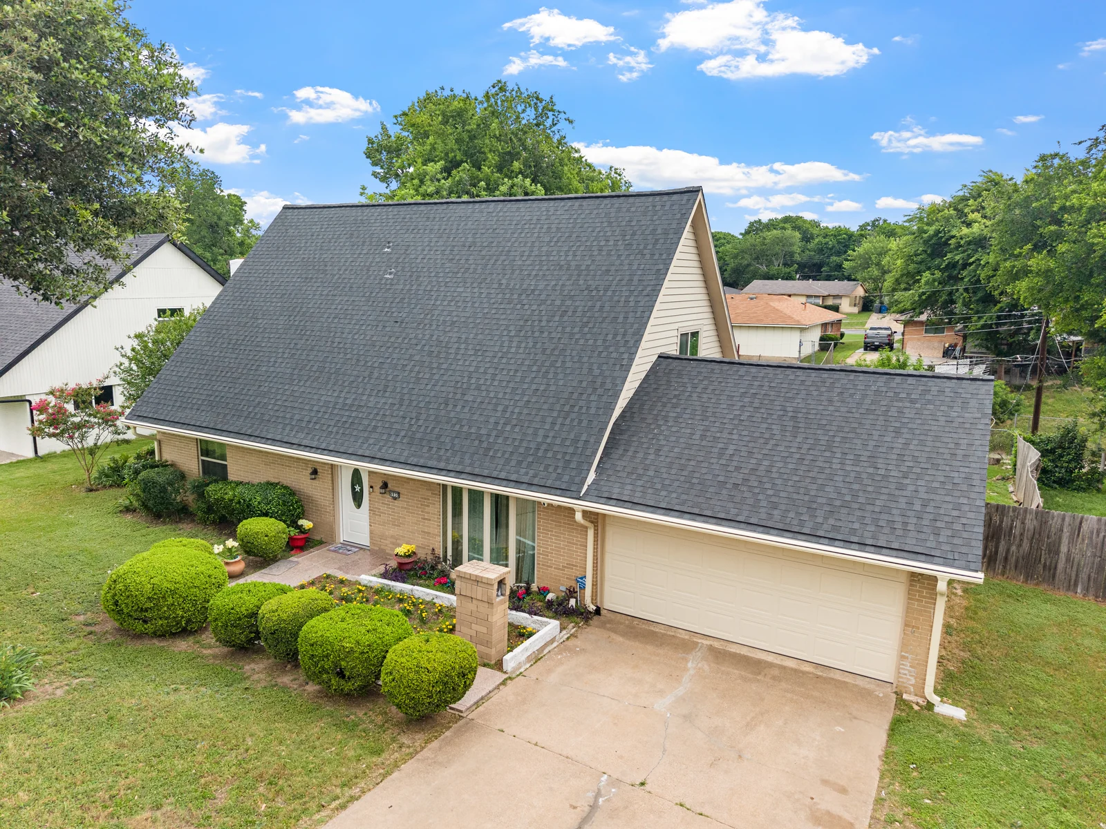Elevated front view of 6930 Trailcrest Drive, showing the roofline, garage and front planting beds