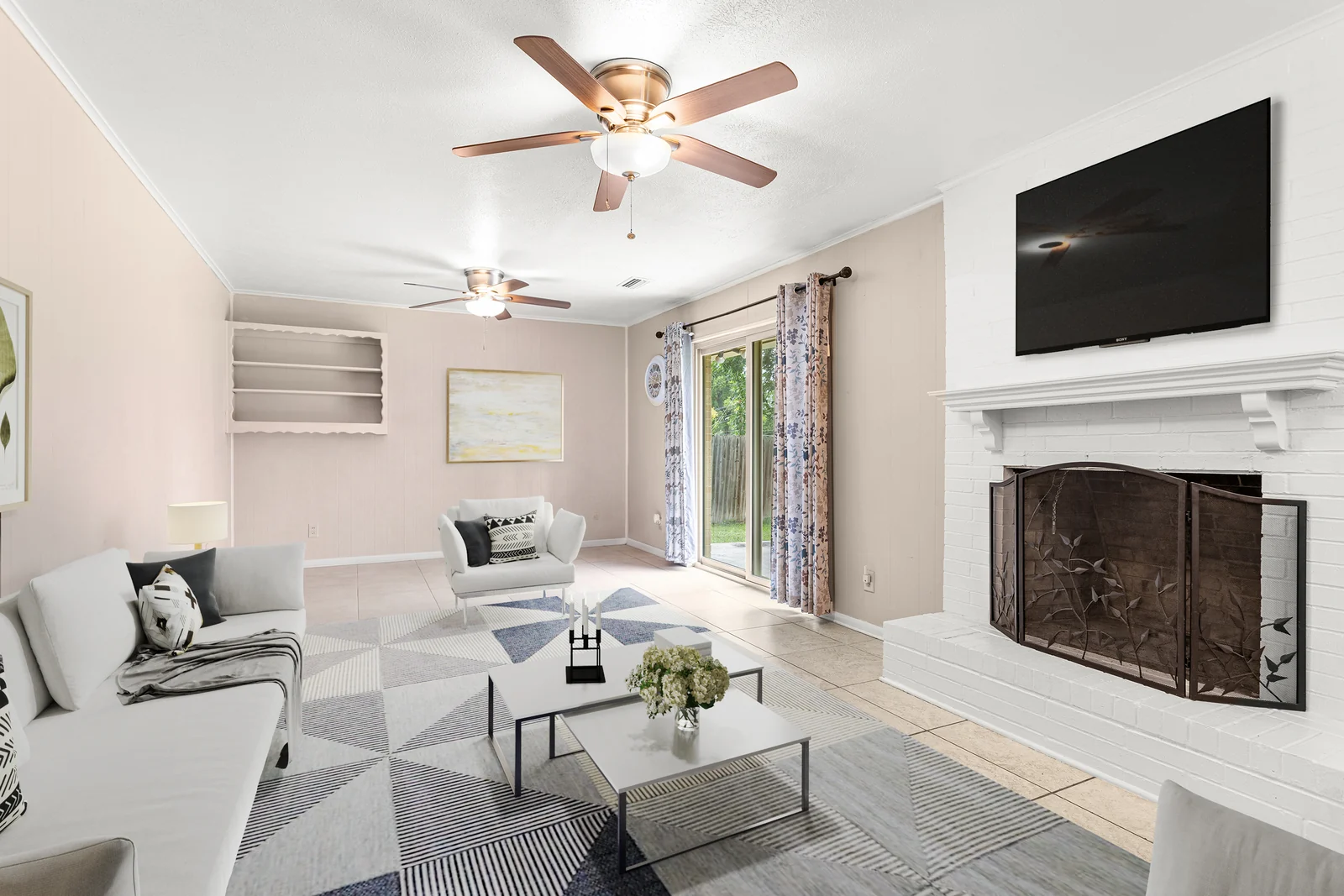 Living-room view at 6930 Trailcrest Drive with a fireplace and glass door to the yard