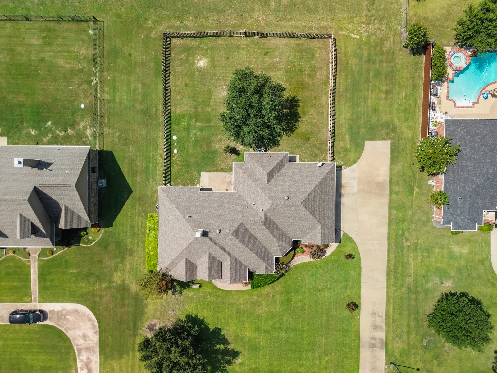 Overhead aerial view of 9530 Blarney Stone Way showing the house, driveway and fenced backyard